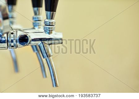 close-up of barman hand at beer tap pouring a draught lager beer