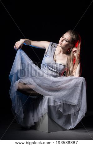Actress In A Grey Dress On A Dark Stage