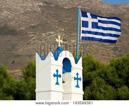 Greek flag on the belfry of Agios Nikolaos church, Parikia, Paros, Cyclades, Greece