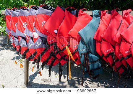Labuan,Malaysia-May 1,2017:Various of life vests or life jackets is hung for drying out in Rusukan Besar island,Labuan,Malaysia.It is filled with buoyant material and used as a life preserver.