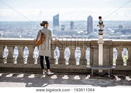 Woman enjoying great view on Lyon city with skyscrapers during the morning in France