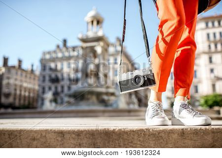 Woman holding a photocamera on the Jacobins fountain background in Lyon city