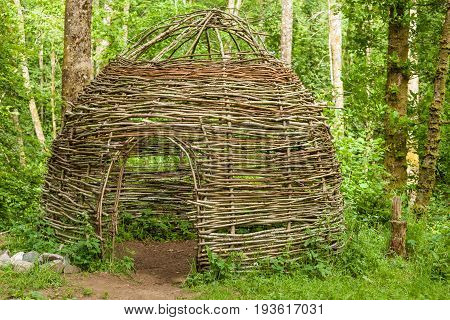 Small Cottage Made Of Wooden Sticks In Woods