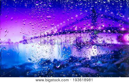 bridge A view of the city from a window from a high point during a rain. Rain drops on glass. Focus on drops
