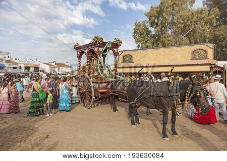 El Rocio Spain - June 2 2017: Piilgrims in traditional spanish dress in front of the hermitage in El Rocio during the Romeria 2017. Andalusia Spain