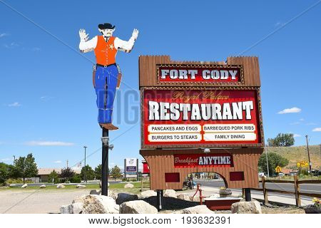 CODY, WYOMING - JUNE 24, 2017: Fort Cody Cowboy Sign. The restaurant is located along the Yellowstone Highway. 
