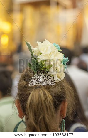 El Rocio Spain - June 2 2017: Female pilgrim in traditional spanish dress in the hermitage of El Rocio during the Romeria 2017. Andalusia Spain