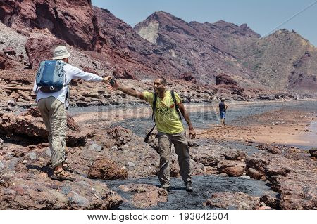 Hormuz Island Hormozgan Province Iran - 17 april 2017: Tourist gives a smartphone to his friend to make a photo.