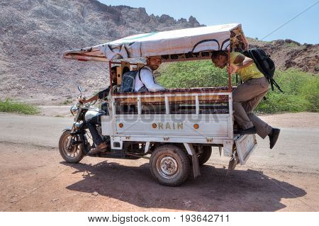 Hormuz Island Hormozgan Province Iran - 17 april 2017: Iranian Island of Hormuz in Persian Gulf Travelers use a three-wheeled motorcycle van for a trip around the island.