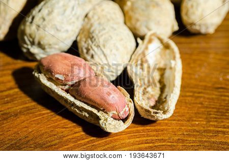 Peanut in shell on dark wooden background. Close up. Selective focus. Peanut.