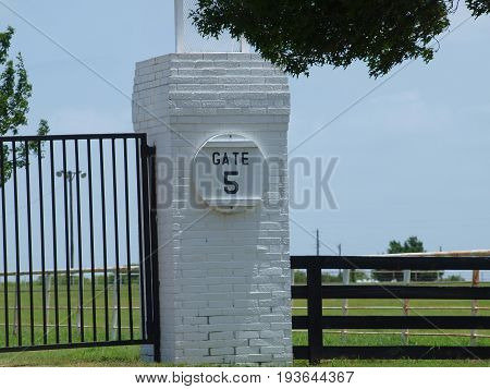Gate 5 entry to a working quarter horse ranch. This entry has a reminder sign that the gates are to be closed and locked  because there are grazing livestock in the area.