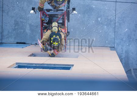 Firefighter Training Entering And Exiting A Building On A Truck Ladder Overhead View