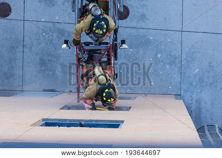 Firefighter Training Entering And Exiting A Building On A Truck Ladder Overhead View