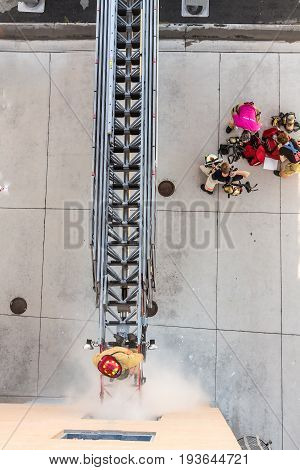 Firefighter Training Entering And Exiting A Building On A Truck Ladder Overhead View