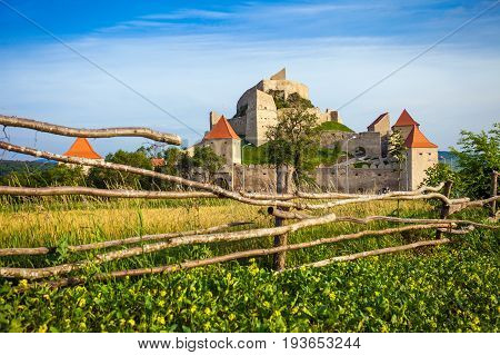 Rupea Romania - June 23 2013: Tourists visiting the old medieval fortress on top of the hill Rupea village located in Transylvania Romania