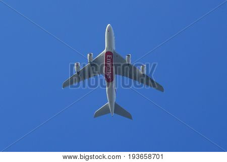 Almere, The Netherlands - July 3, 2017: Emirates Airbus A380-800 (A6-EDR) flies above the city of Almere.