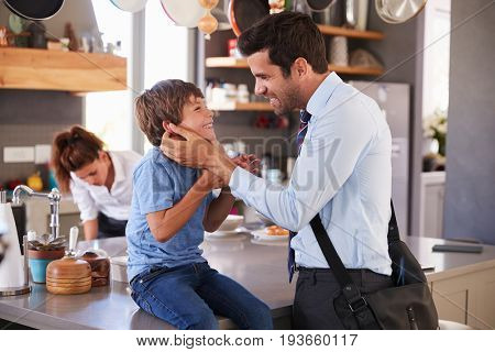 Father Saying Goodbye To Son As He Leaves For Work