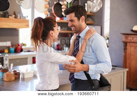 Husband Saying Goodbye To Wife As He Leaves For Work