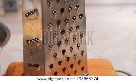 A Grater For Rubbing Vegetables And Potatoes Close-up. Preparation Of Ukrainian Deruns. Recipe For T