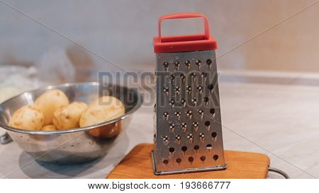 A Grater For Rubbing Vegetables And Potatoes Close-up. Preparation Of Ukrainian Deruns. Recipe For T