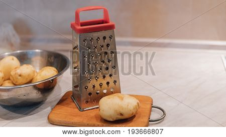 A Grater For Rubbing Vegetables And Potatoes Close-up. Preparation Of Ukrainian Deruns. Recipe For T