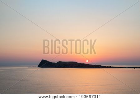 Sunrise on the beach, early morning in Kolokitha island, Crete, Greece