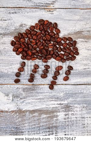 Image of rain from coffee. Coffee beans on wooden background. Wet weather with coffee.