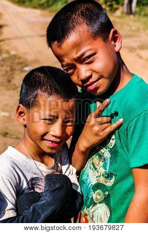MUANG SING, LAOS - DECEMBER 28, 2012: Local boys in a small ethnic community near the village of Muang Sing in Laos