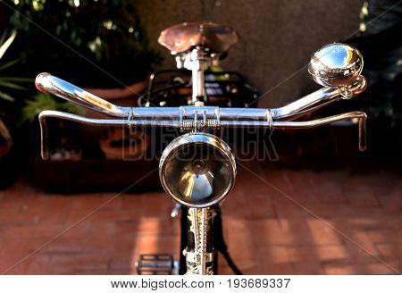 Vintage bike handlebar, with an antique light beacon, bell, brakes
