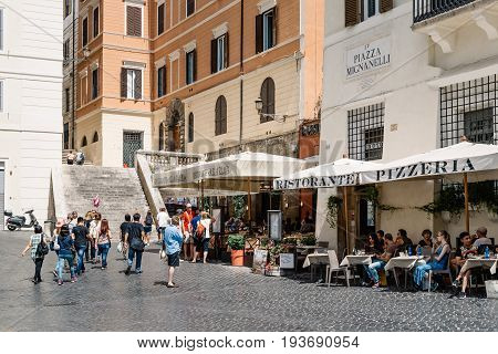 Rome Italy - August 18 2016: Sidewalk restaurant with tourists in Mignanelli Square in Rome a sunny summer day