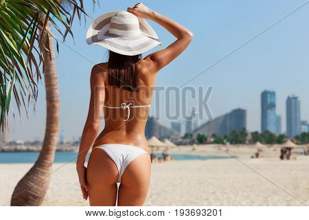 Sexy Back Of A Beautiful Unrecognizable Woman Relaxing And Sunbathing In Bikini On Sea Background An
