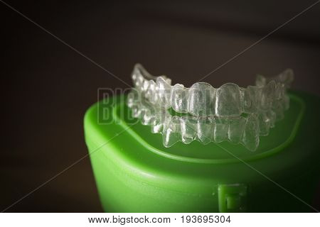 Plastic dental orthodontics on colored background. No people