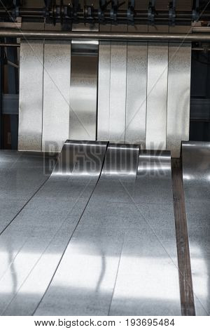 Galvanized steel metal strips exiting the slitting line