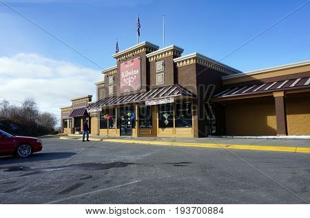 PETOSKEY, MICHIGAN / UNITED STATES - SEPTEMBER 22, 2016: A man approaches the front entrance of Kilwins of Petoskey, which offers hand-crafted fudge, original recipe ice cream, and free chocolate tours.