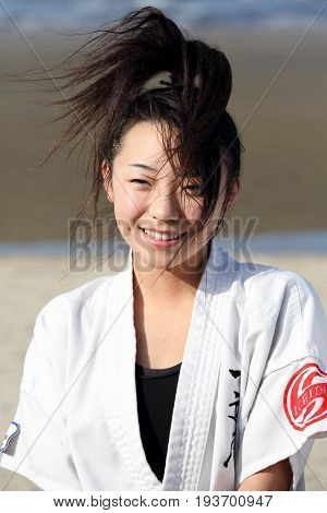 Kagawa, Japan - January 3, 2017: Japanese martial arts houses, young girl training of karate at the new year at the Ichinomiya beach.