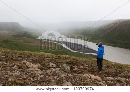 Iceland Hiking, Adventure Concept. Single Male Traveler Standing On The Hill Near Asbyrgi And Pointi