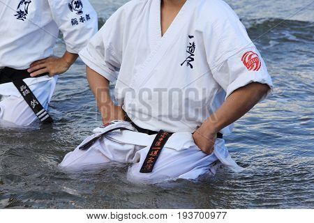 Kagawa, Japan - January 3, 2017: Japanese martial arts houses sports competitions, sit in meditation pose on the Ichinomiya Beach,