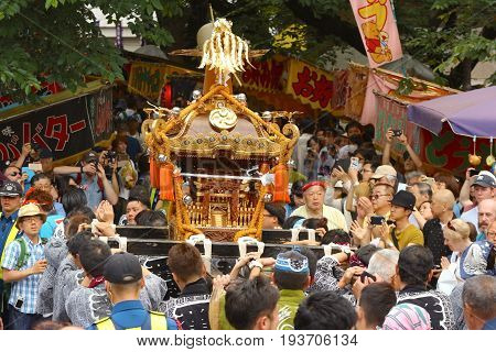 2017 05 28. SHINJUKU TOKYO JAPAN. People are carrying a portable shrine on their shoulders and walking around shinjuku city. known as OMIKOSHI MASTURI FESTIVAL at HANAZONO JINJA, SHINJUKU TOKYO JAPAN