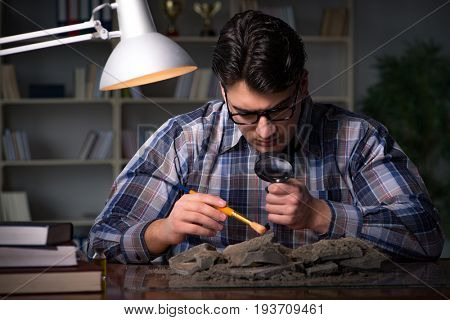 Archeologist working late night in office