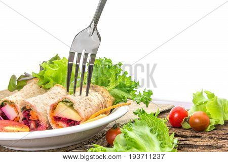 the fresh whole wheat bread wraps with vegetables and fruit on the plate healthy and clean food concept