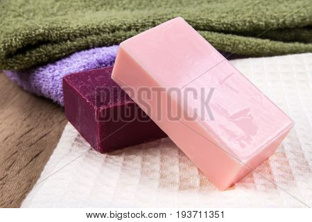 thenatural soap bar with bath towel on wooden background