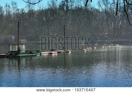 Dredger Floating excavator when dredging of soil sand and silt from a river.