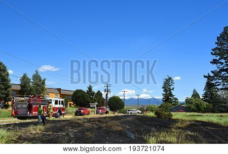 KALISPELL, MONTANA, USA - June 21, 2017: Fire and police crews on scene at a grass fire