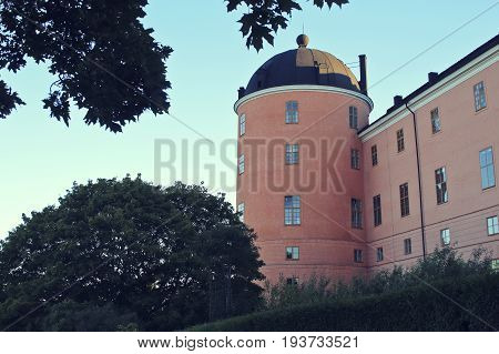 Beautiful summer season specific photograph. An old castle in Uppsala, Sweden. Great colors and beautiful blue sky.