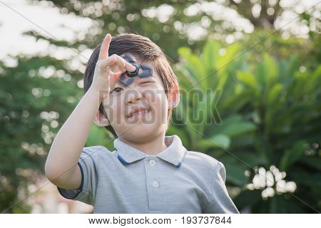 Chld  Playing  Fidget Spinner On Nature Background