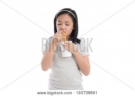 Beautiful asian girl eating instant noodle on white background isolated