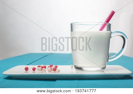 Conceptual still life with yogurt and pills. Healthy food. Horizontal.