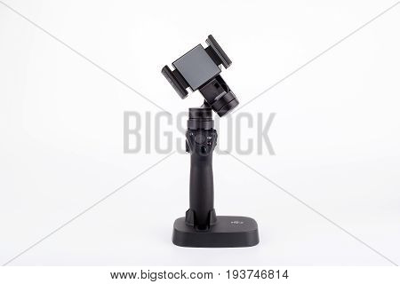 Riga, Latvia - July 3, 2017: New DJI Osmo Mobile gimbal stand for smartphone. The DJI Osmo hardware and mobile app allows smooth video shooting. 4k, Ultra HD