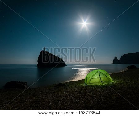 Tent on the beach with rocks and a night sky with stars. Fiolent. Crimea.