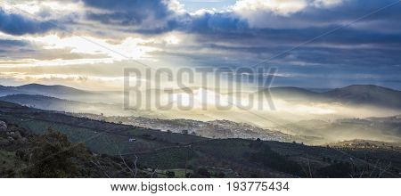 Stunning overview of Guadalupe village during a foggy sunrise Caceres Spain. Panoramic view